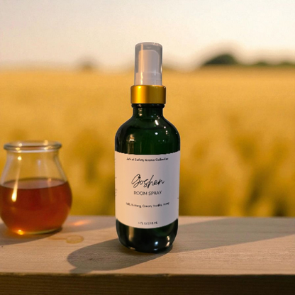 Room spray bottle with a jar of honey on a wooden surface with a blurred natural background